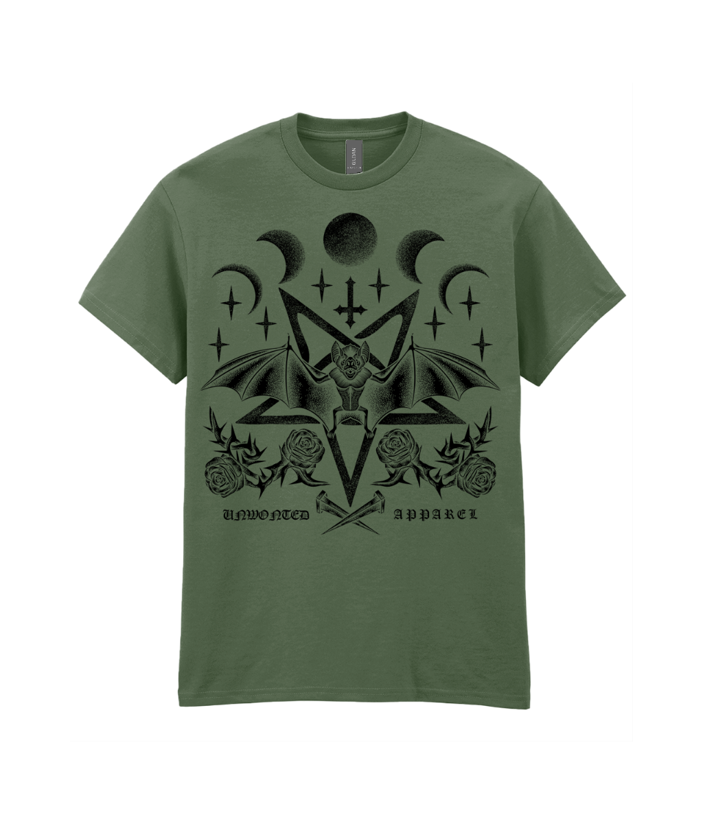 An olive green short-sleeve t-shirt with a black gothic-style graphic print featuring a horned skull, crescent moons, stars, roses, and the text 'unhewn apparel' on a white background.